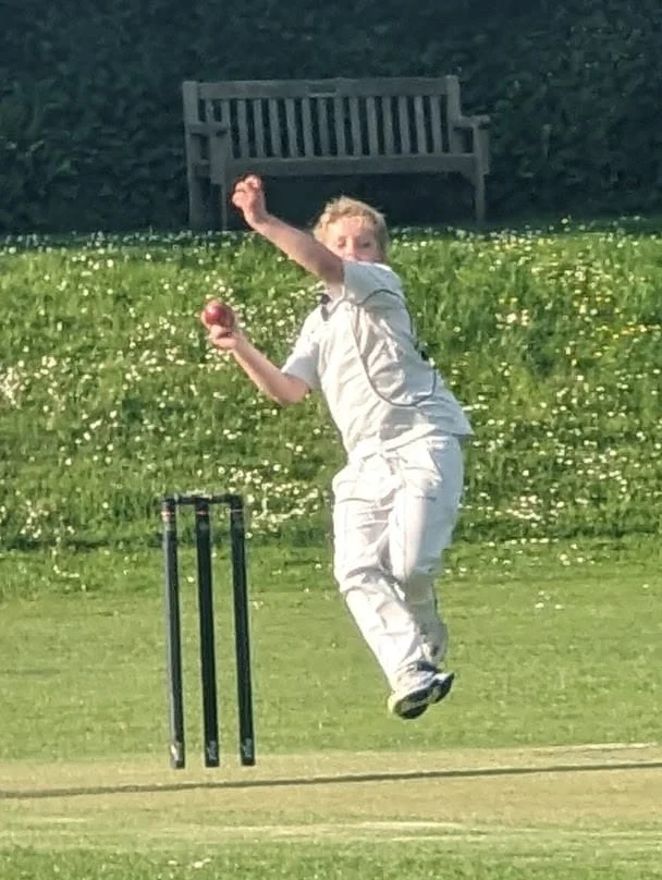 Junior bowler in action during cricket training